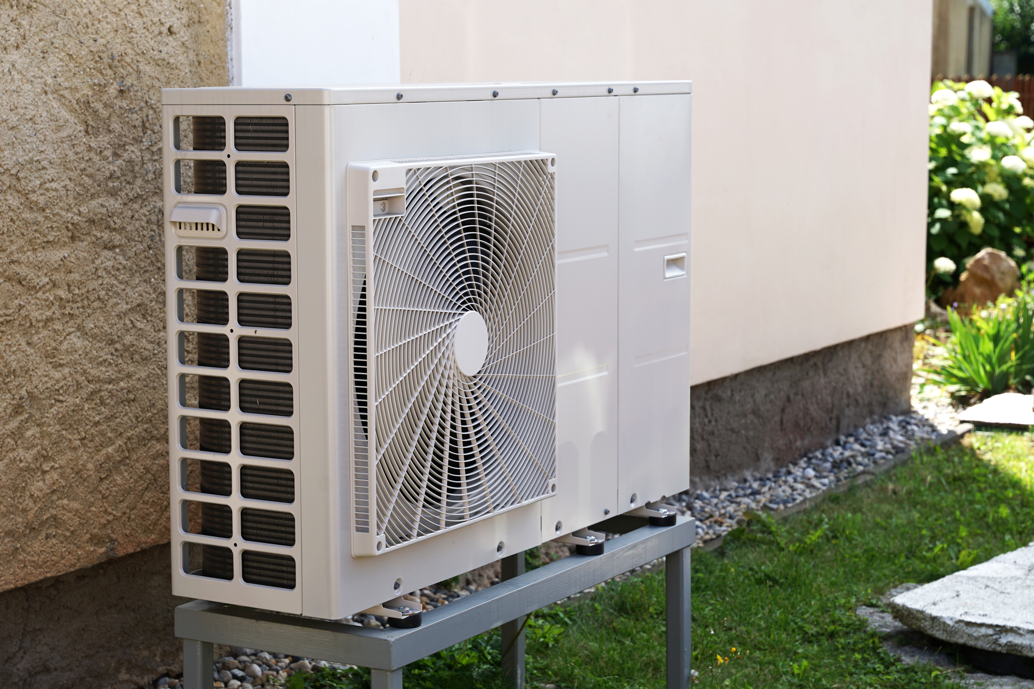 Heat pump mounted on the outside wall of a Michigan home