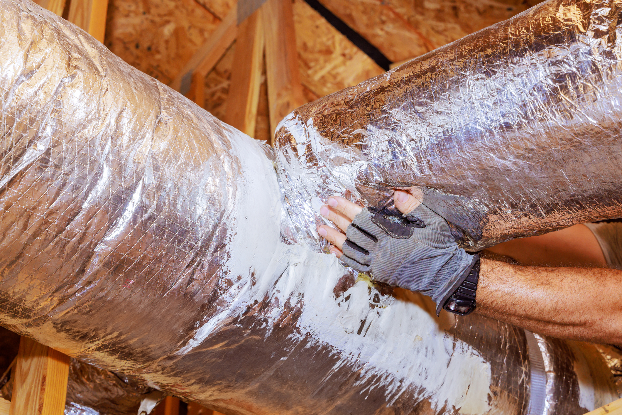 Hands on newly sealed ductwork