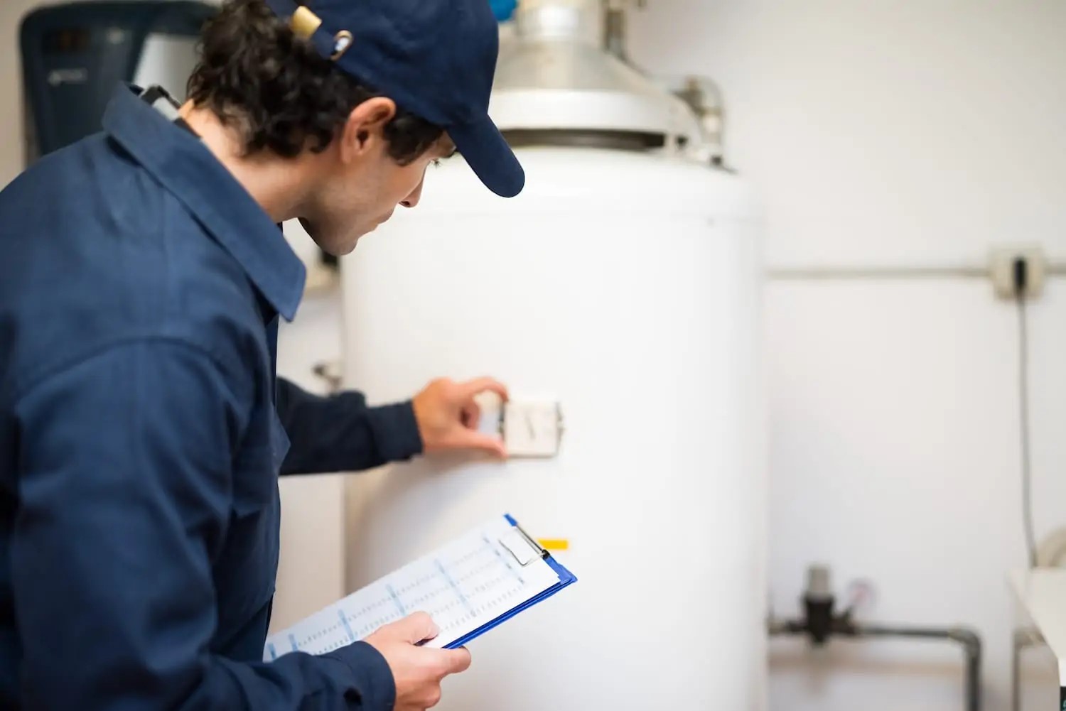 Plumber with hand on a newly installed water heater