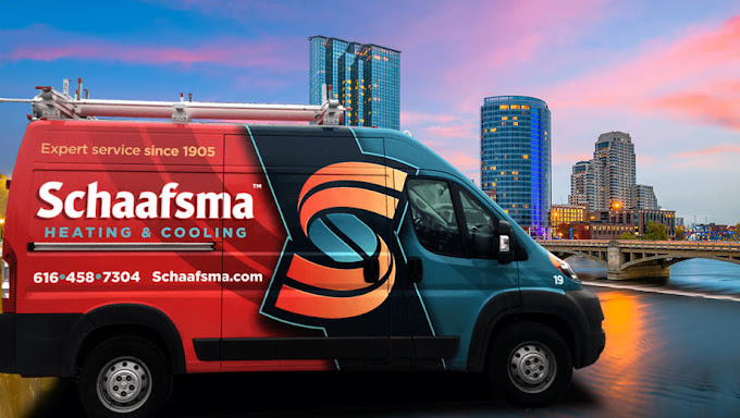 Schaafsma Heating & Cooling truck parked in front of Grand Rapids, MI skyline.