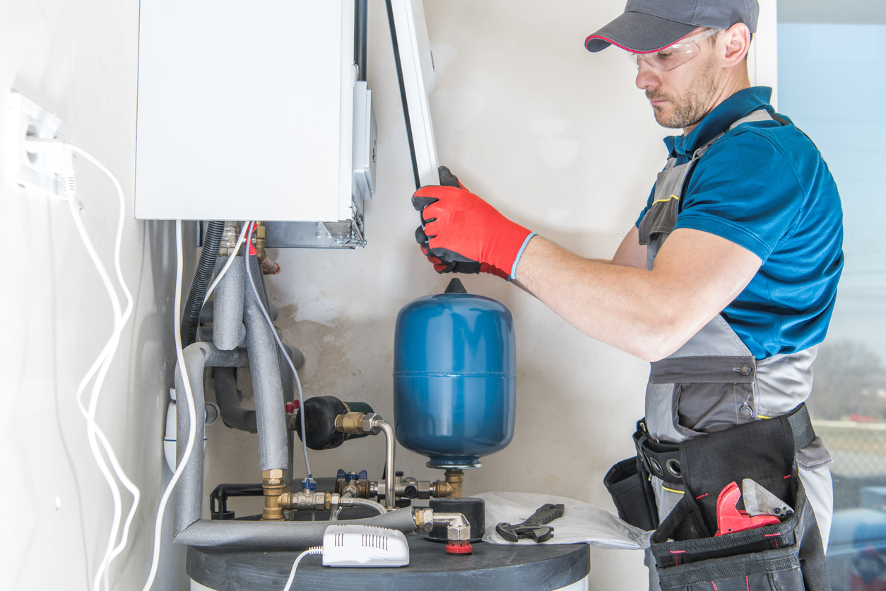 HVAC technician replacing the front of a gas heating system