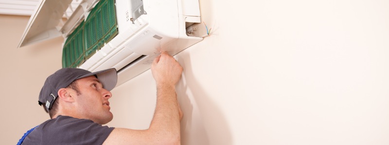 HVAC technician working on ductless mini-split