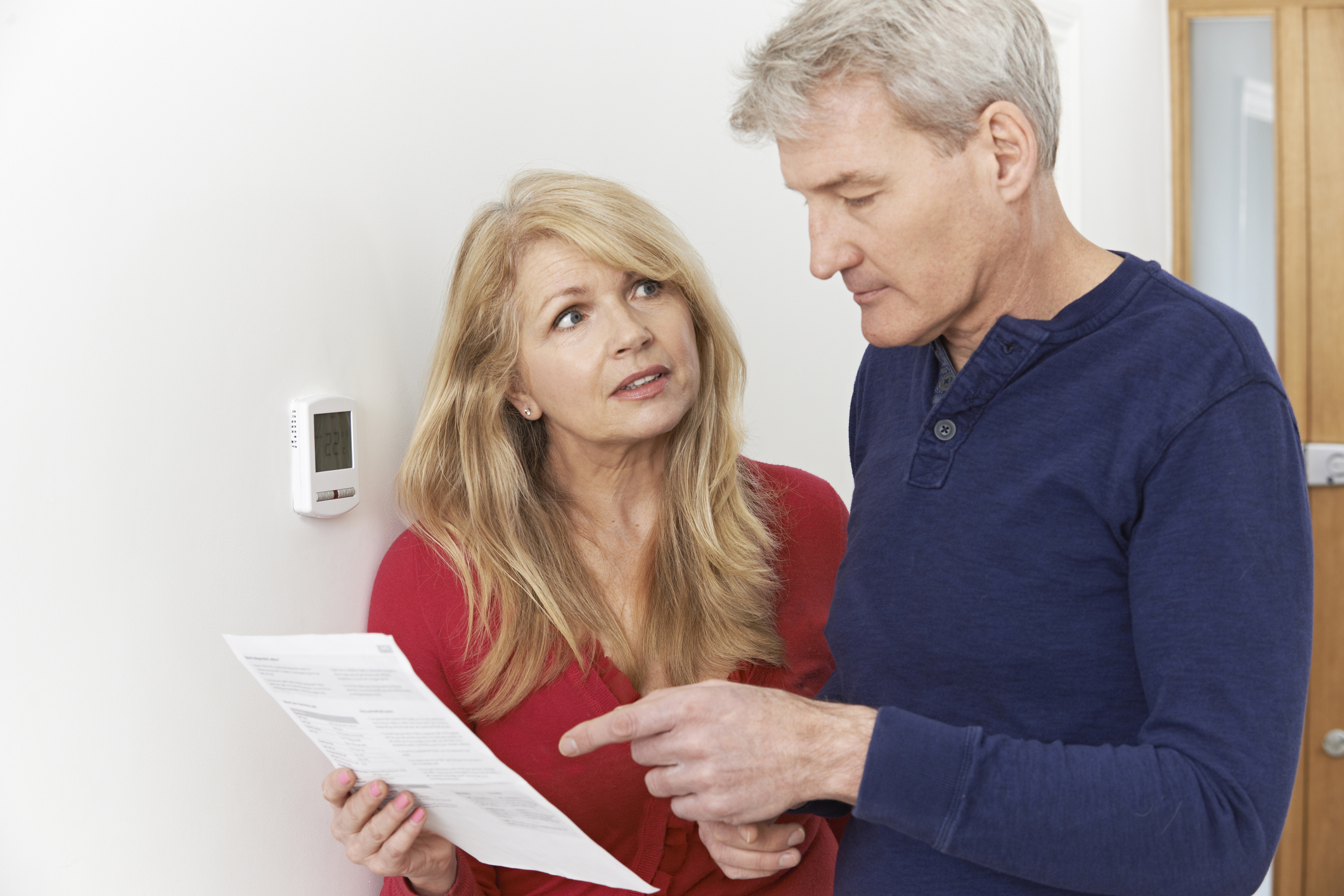 Couple looking at a high energy bill
